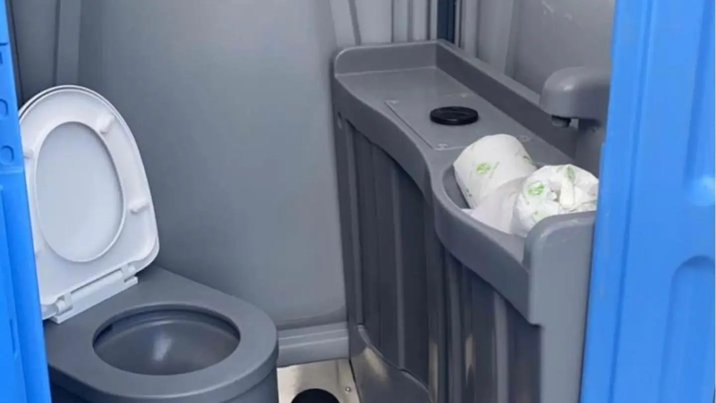 Deluxe porta potty interior with a sink and mirror