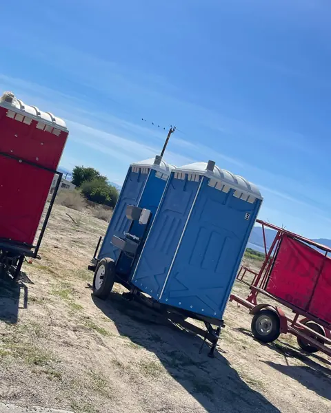 Porta potties on a transport trailer at a field site