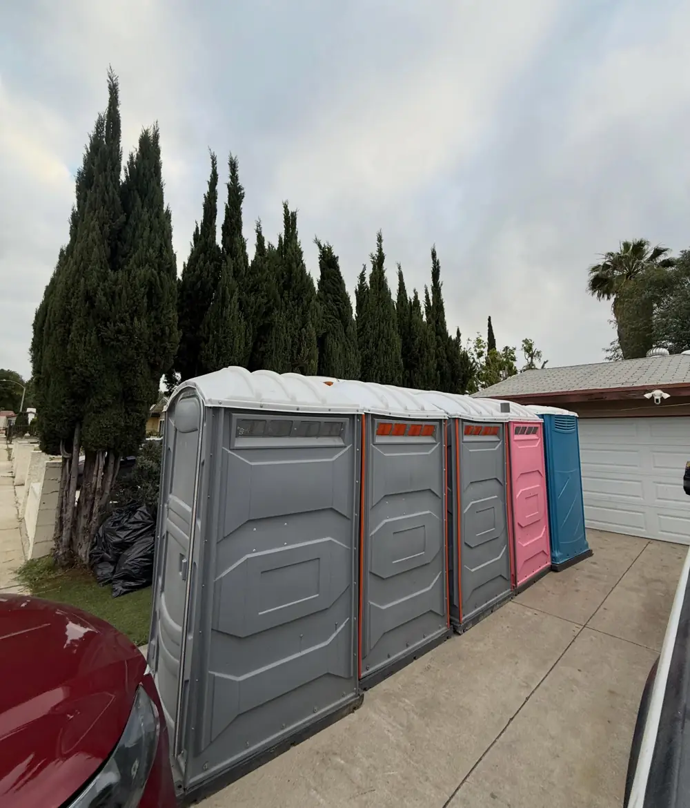 Row of porta potties along a residential lot