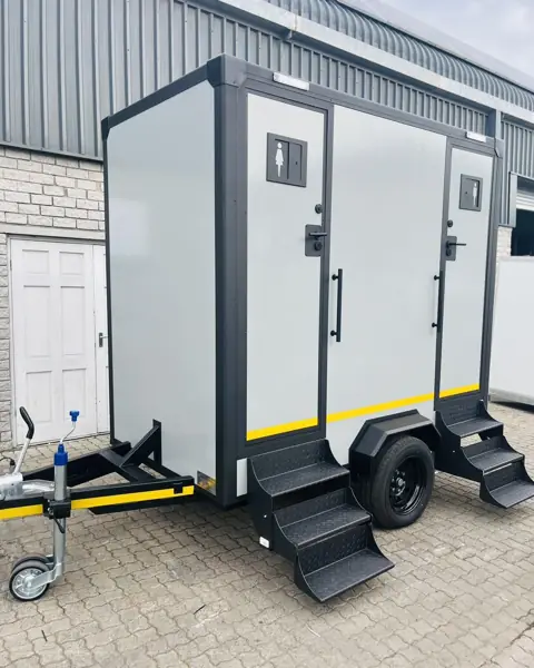 Two-door restroom trailer with folding steps