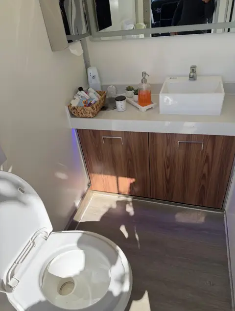 Wood vanity and vessel sink inside a VIP trailer